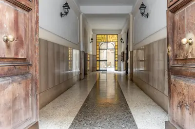 an empty hallway with wooden doors and a hallway with a hallwayngth at Le Stanze di Rinaldo in Rome
