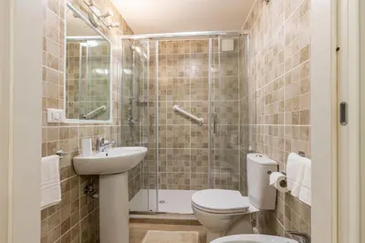 a bathroom with a toilet and a sink and a shower at Le Stanze di Rinaldo in Rome