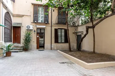 a building with a tree in front of it at Le Stanze di Rinaldo in Rome