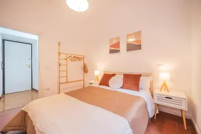 a bedroom with a bed and a table and two lamps at Gazometro Rome Holiday House - Rome Vacation M&D in Rome