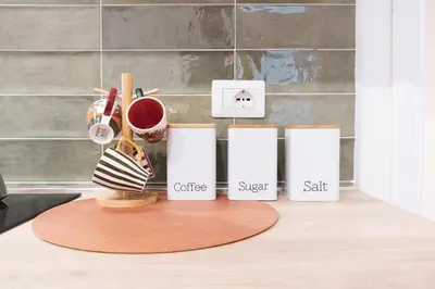 a counter with three coffee cups and a coffee sugar sack at Gazometro Rome Holiday House - Rome Vacation M&D in Rome