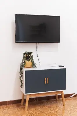 a flat screen tv on top of a black and white cabinet at Gazometro Rome Holiday House - Rome Vacation M&D in Rome