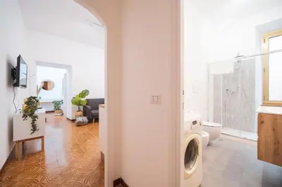 a living room with a washing machine in a bathroom at Gazometro Rome Holiday House - Rome Vacation M&D in Rome
