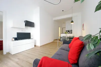 a living room with a blue couch and red pillows at 4BNB - Cozy Albornoz Flat in Rome