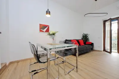 a living room with a table and chairs and a couch at 4BNB - Cozy Albornoz Flat in Rome