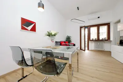 a dining room with a white table and chairs at 4BNB - Cozy Albornoz Flat in Rome