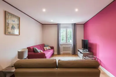 a living room with a couch and a pink wall at Daniela's Place in Rome