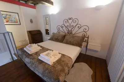 a bedroom with a bed with two towels on it at Charm and Style by Campo de Fiori in Rome