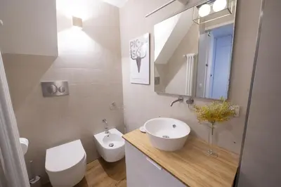 a bathroom with a sink and a toilet and a mirror at Charm and Style by Campo de Fiori in Rome