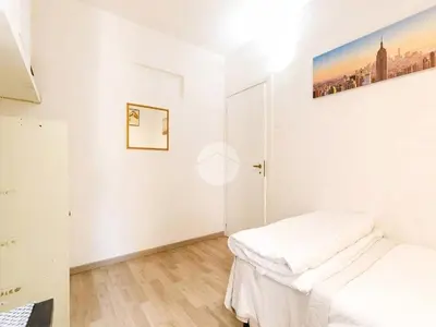 a bedroom with a bed and a desk in it at 
