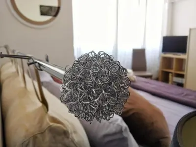 a metal sculpture on the side of a bed at 