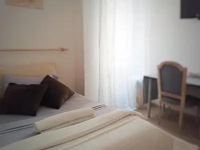 a bedroom with a bed with a chair and a window at 
