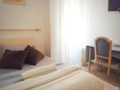 a bedroom with a bed with a chair and a window at 