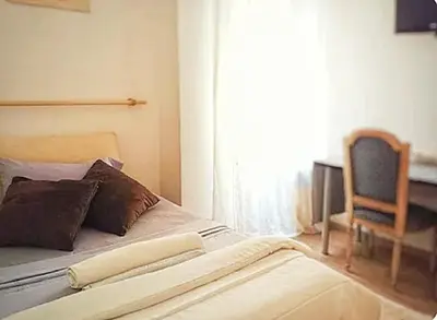 a bed in a room with a chair and a window at 