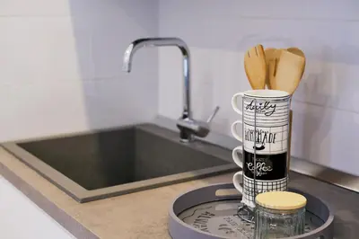 a kitchen counter with a container with wooden utensils at Remuria Domus in Rome