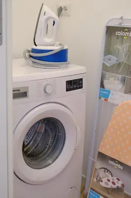 a washing machine with dishes on top of it at Remuria Domus in Rome