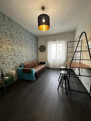 a living room with a couch and a brick wall at DOMUS H501 in Rome