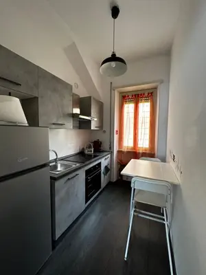 a kitchen with a sink and a table in it at DOMUS H501 in Rome