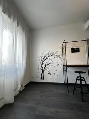 a bedroom with a tree mural on the wall at DOMUS H501 in Rome