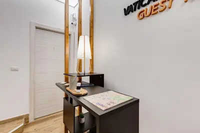a desk with a lamp on it next to a door at VATICANDREAM GUEST HOUSE in Rome