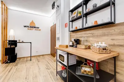 a kitchen with a counter and a wooden wall at VATICANDREAM GUEST HOUSE in Rome