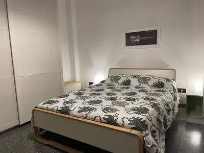 a bedroom with a bed with a black and white blanket at Your comfy Home in Rome