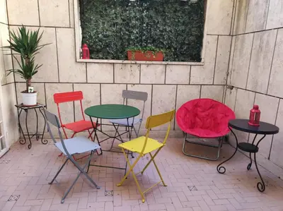 a group of different colored chairs and tables at Your comfy Home in Rome