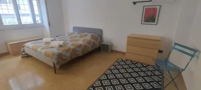 a bedroom with a bed and a dresser and a chair at Your comfy Home in Rome