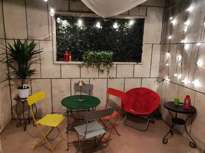 a room with colorful chairs and tables and lights at Your comfy Home in Rome