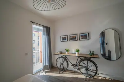 a bike on a table in a room with a mirror at Vintage Cipro Apartment in Rome