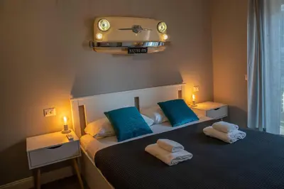 a bedroom with a bed with towels on it at Vintage Cipro Apartment in Rome