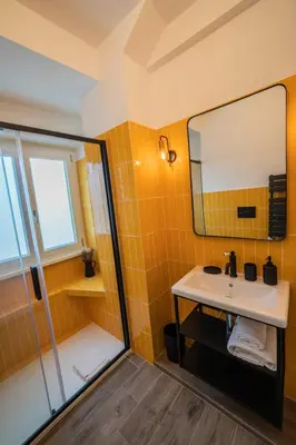 a bathroom with a sink and a shower at Vintage Cipro Apartment in Rome