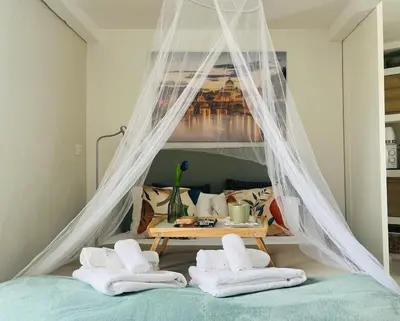 a bedroom with a bed with a table and towels at Monteverde Double Terrace Penthouse in Rome