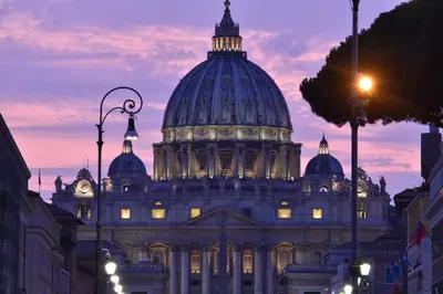 a domed building with a clock tower on top of it at Moderno appartamento Cornelia-San Pietro con Giardino in Rome