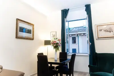 a dining room with a table and a window at C&Y Apartments - Roma Vaticano St Peter - Luxe Penthouse Flat in Rome