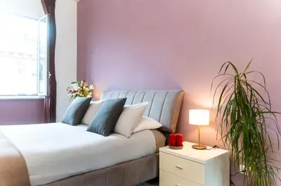 a living room with a couch and a plant at C&Y Apartments - Roma Vaticano St Peter - Luxe Penthouse Flat in Rome