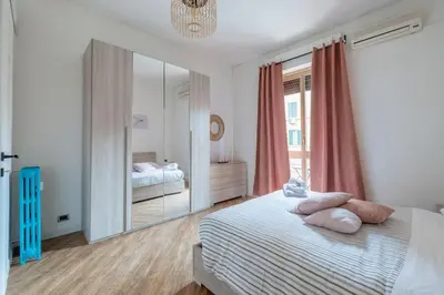 a bedroom with a bed and a large mirror at Colosseo Roma color's in Rome