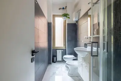 a bathroom with a toilet and a sink at Colosseo Roma color's in Rome