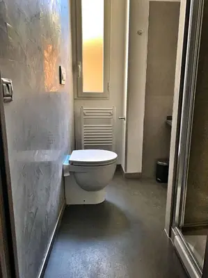 a bathroom with a white toilet in a room at Avignonesi Flat in Rome