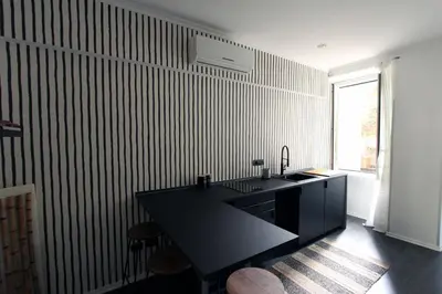 a kitchen with a black counter and a black counter top at Avignonesi Flat in Rome