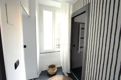 a hallway with a door into a room with a window at Avignonesi Flat in Rome