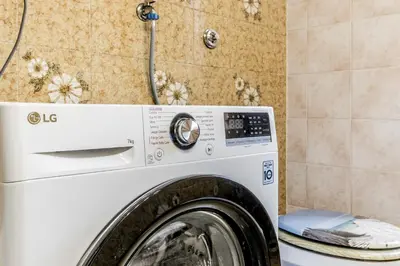 a washing machine in a bathroom with a shower at MARCONI31Eredia in Rome