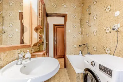 a bathroom with a white sink and a tub at MARCONI31Eredia in Rome