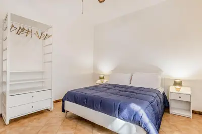 a bedroom with a bed and a white closet at MARCONI31Eredia in Rome