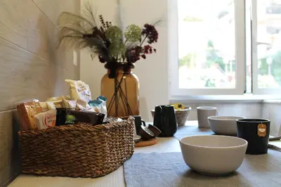 a table with a basket and bowls on it at San Pietro Sweet RHome in Rome
