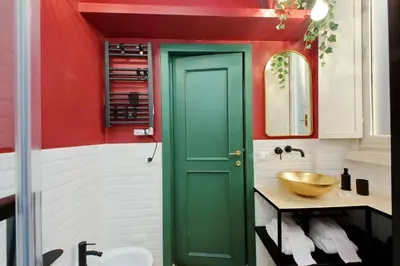 a green door in a bathroom with a sink at YCH-Bright Suite Navona in Rome