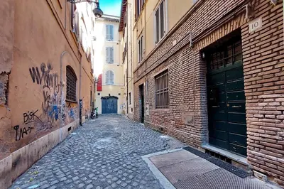 an empty alley with a brick building and a building with a garage at YCH-Bright Suite Navona in Rome