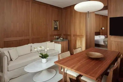 a bedroom with a bed and a table and a couch at The Rome EDITION in Rome
