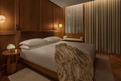 a bedroom with a bed and a television on a wall at The Rome EDITION in Rome