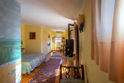 a hotel room with two beds and a television at Angel's Terrace in Rome